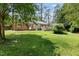 Lush backyard featuring a spacious deck, patio, and plenty of room for outdoor activities at 509 E Millbrook Rd, Raleigh, NC 27609