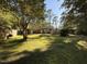 Enjoy this home's backyard with a wood deck and mature trees at 509 E Millbrook Rd, Raleigh, NC 27609
