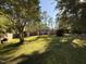 Enjoy this home's large yard with a wood deck surrounded by mature trees at 509 E Millbrook Rd, Raleigh, NC 27609
