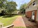 Brick and grass backyard with a well-maintained lawn and mature trees at 509 E Millbrook Rd, Raleigh, NC 27609