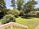 Large backyard with lush greenery and a wooden fence, creating a private oasis at 509 E Millbrook Rd, Raleigh, NC 27609