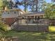An expansive wooden deck offers ample space for outdoor seating and gatherings in a serene backyard setting at 509 E Millbrook Rd, Raleigh, NC 27609
