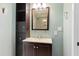 Bathroom featuring a vanity with storage and a framed mirror reflecting the tiled shower at 509 E Millbrook Rd, Raleigh, NC 27609