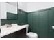 Stylish bathroom with a modern vanity and beautiful green board and batten accent wall at 509 E Millbrook Rd, Raleigh, NC 27609