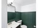 Stylish bathroom with a modern vanity and beautiful green board and batten accent wall at 509 E Millbrook Rd, Raleigh, NC 27609