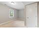 Bedroom featuring a neutral color palette, closet, and a large window with natural light at 509 E Millbrook Rd, Raleigh, NC 27609