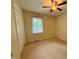 This bedroom features neutral carpet and walls, a ceiling fan, and a window with blinds at 509 E Millbrook Rd, Raleigh, NC 27609