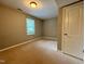 Cozy bedroom featuring neutral carpet, a window, and closet space at 509 E Millbrook Rd, Raleigh, NC 27609