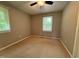 This bedroom features neutral carpet and walls, a ceiling fan, and two windows with blinds at 509 E Millbrook Rd, Raleigh, NC 27609