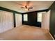 This bedroom features two windows with blinds, two closets, and a ceiling fan at 509 E Millbrook Rd, Raleigh, NC 27609