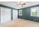Bedroom with soft carpet, a ceiling fan and two bright windows at 509 E Millbrook Rd, Raleigh, NC 27609