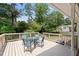 A spacious wooden deck with outdoor seating surrounded by lush greenery at 509 E Millbrook Rd, Raleigh, NC 27609