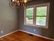 Dining room with hardwood floors and a window with a view of the backyard deck at 509 E Millbrook Rd, Raleigh, NC 27609