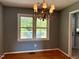 Dining room featuring a chandelier and a view of the backyard deck through a window at 509 E Millbrook Rd, Raleigh, NC 27609