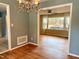 Dining room with view into living room, showcasing hardwood floors and neutral paint at 509 E Millbrook Rd, Raleigh, NC 27609