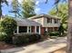 Charming two-story home with mixed siding and brick facade, accented by black shutters and lush landscaping at 509 E Millbrook Rd, Raleigh, NC 27609