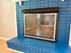 Close up of dark blue painted brick fireplace in living room at 509 E Millbrook Rd, Raleigh, NC 27609