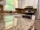 Close up of kitchen with stainless steel appliances and granite countertops at 509 E Millbrook Rd, Raleigh, NC 27609