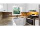 Bright kitchen with stainless appliances, stone countertops and a beautiful window view at 509 E Millbrook Rd, Raleigh, NC 27609