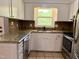 Bright kitchen with white cabinets and granite countertops at 509 E Millbrook Rd, Raleigh, NC 27609