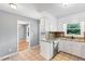 A bright kitchen featuring stainless steel appliances, ample cabinet space, and light gray walls at 509 E Millbrook Rd, Raleigh, NC 27609