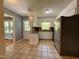 Bright kitchen with white cabinets, granite countertops, stainless steel appliances, and tiled floors at 509 E Millbrook Rd, Raleigh, NC 27609