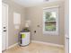 Functional laundry room features a water heater and window letting in natural light at 509 E Millbrook Rd, Raleigh, NC 27609