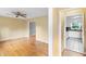 Spacious living room with hardwood floors, ceiling fan, and access to the kitchen at 509 E Millbrook Rd, Raleigh, NC 27609