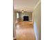 Large living room featuring a dark blue painted fireplace, a ceiling fan and wood floors at 509 E Millbrook Rd, Raleigh, NC 27609