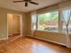 Living room with hardwood floors, large windows with sheer curtains, and doorway at 509 E Millbrook Rd, Raleigh, NC 27609