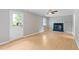 Bright living room area with new floors, fireplace, and a door to the backyard at 509 E Millbrook Rd, Raleigh, NC 27609
