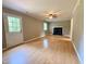 Spacious living room showcasing a fireplace and a ceiling fan and access to front door at 509 E Millbrook Rd, Raleigh, NC 27609