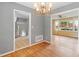 Open-concept living room with hardwood floors, chandelier, and an open layout at 509 E Millbrook Rd, Raleigh, NC 27609
