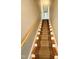 Carpeted staircase featuring wood banister and treads, leading to upper level at 509 E Millbrook Rd, Raleigh, NC 27609