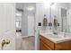 Bathroom with a white sink and wood vanity, featuring view into an adjacent bedroom at 5416 Whisperwood Dr, Durham, NC 27713