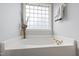 Relaxing bathtub area with a decorative window, perfect for unwinding after a long day at 5416 Whisperwood Dr, Durham, NC 27713