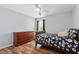 Comfortable bedroom with wood floors and a window, providing natural light and a warm atmosphere at 5416 Whisperwood Dr, Durham, NC 27713