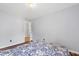 Simple bedroom with hard wood floors, light gray walls, and a patterned bedspread at 5416 Whisperwood Dr, Durham, NC 27713