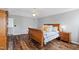 Cozy bedroom featuring a ceiling fan, wood floors, and warm lighting creating an inviting atmosphere at 5416 Whisperwood Dr, Durham, NC 27713