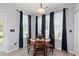 Dining room with wood table, natural light, and navy curtains at 5416 Whisperwood Dr, Durham, NC 27713