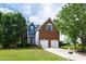 Beautiful two-story brick house featuring a well-kept lawn, an attached garage, and inviting curb appeal at 5416 Whisperwood Dr, Durham, NC 27713