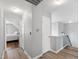 Bright hallway with hardwood floors leading to a bedroom with ample natural light at 5416 Whisperwood Dr, Durham, NC 27713