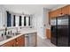 Bright kitchen with stainless steel appliances, double sink, and wooden cabinets at 5416 Whisperwood Dr, Durham, NC 27713
