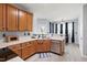 Well-lit kitchen with wood cabinets, a stainless steel dishwasher, and hardwood floors at 5416 Whisperwood Dr, Durham, NC 27713
