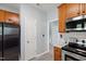 Modern kitchen with stainless steel appliances and wood cabinets at 5416 Whisperwood Dr, Durham, NC 27713