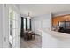 Bright kitchenette with hardwood floors, a breakfast bar, and access to the dining room at 5416 Whisperwood Dr, Durham, NC 27713