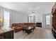 Bright living room featuring a fireplace, hardwood floors, and large windows at 5416 Whisperwood Dr, Durham, NC 27713
