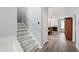 Staircase leading to the living area with fireplace and ample natural light at 5416 Whisperwood Dr, Durham, NC 27713