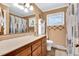 Bathroom featuring a spacious vanity, a large mirror, and natural lighting at 585 Cokesbury Rd, Fuquay Varina, NC 27526