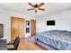 Simple bedroom featuring hardwood floors, a ceiling fan, and ample space for a bed and desk at 585 Cokesbury Rd, Fuquay Varina, NC 27526